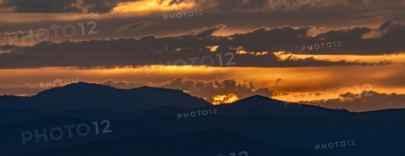 Beautiful sunset over silhouettes of mountains