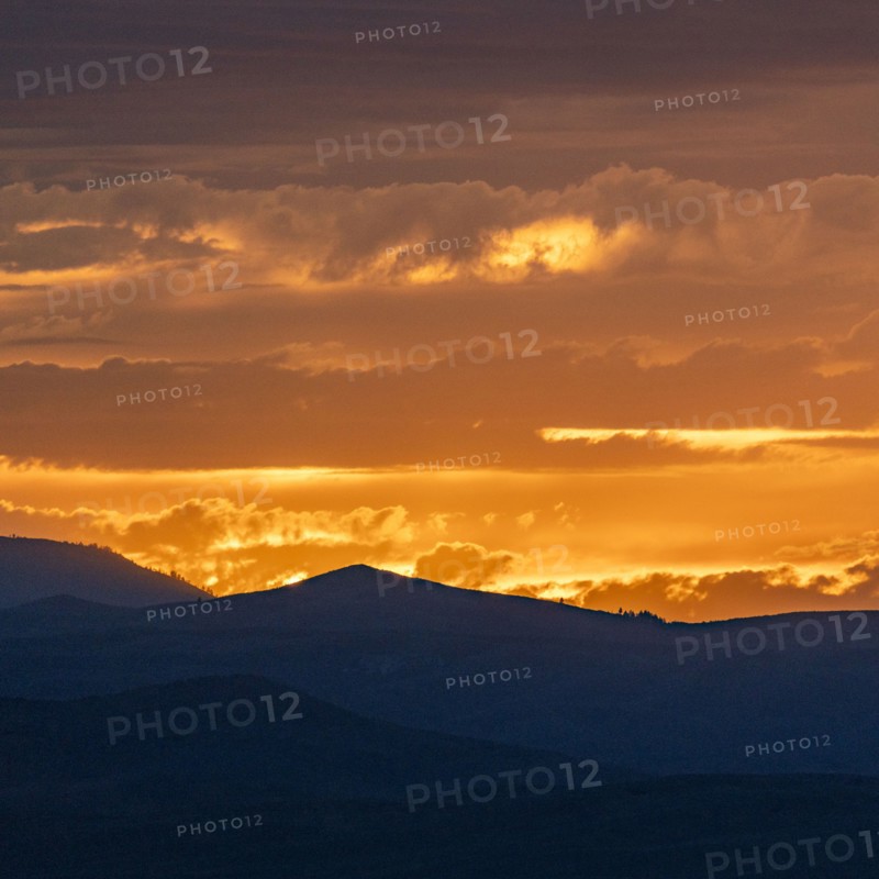 Beautiful sunset over silhouettes of mountains