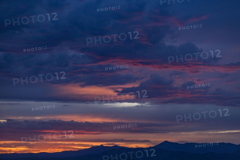 Beautiful sunset over silhouettes of mountains