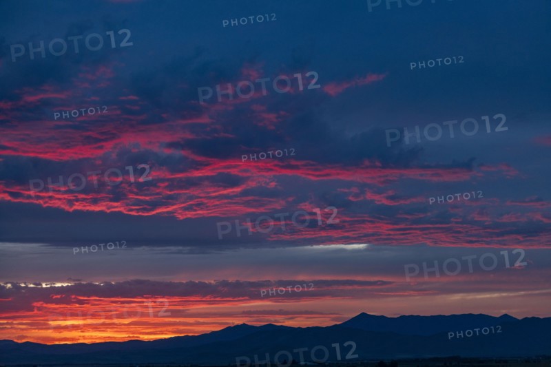 Beautiful sunset over silhouettes of mountains
