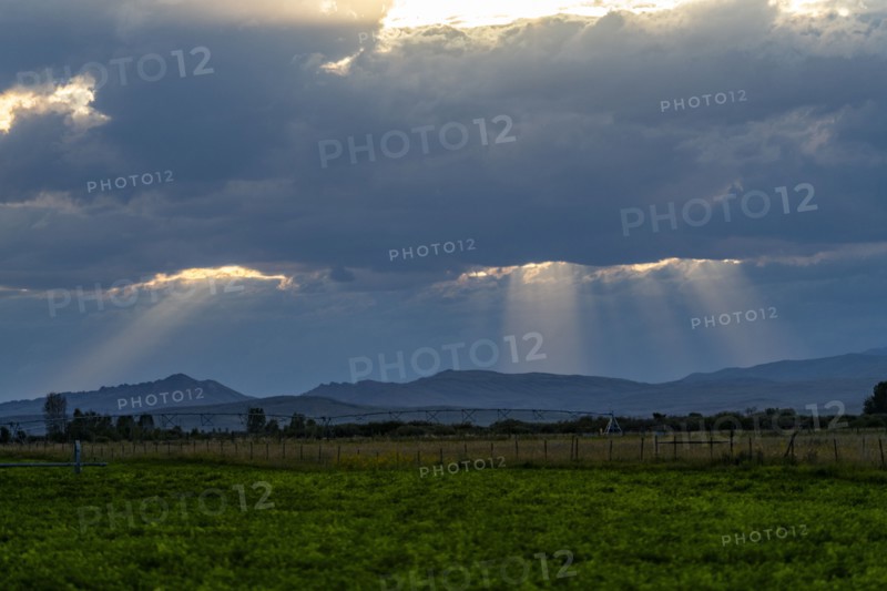 Sunlight shining through dark clouds at sunset