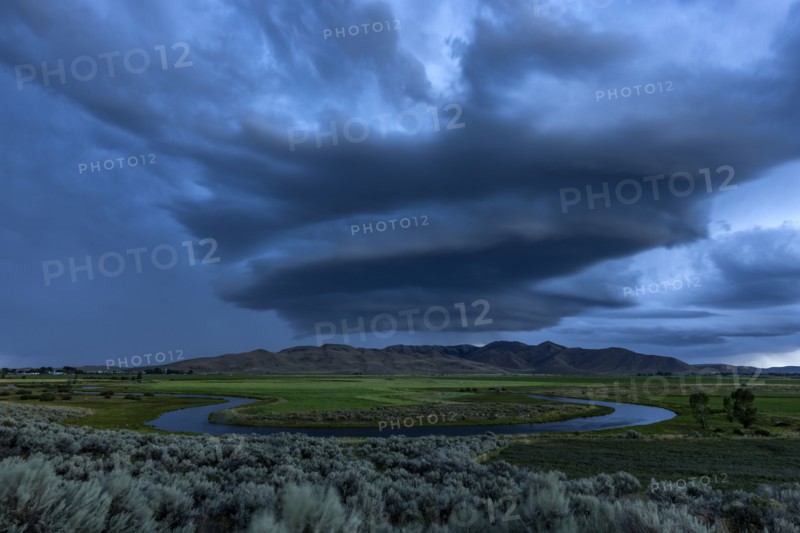 Arcus cumulonimbus storm clouds rolling across farmland