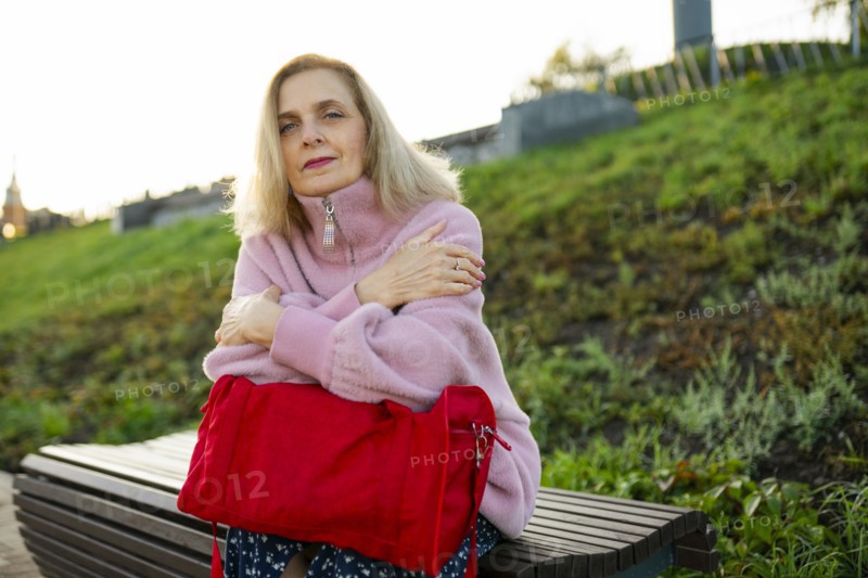 Portrait of serious woman sitting on bench