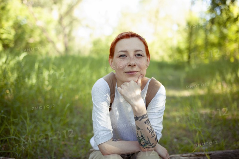 Portrait of smiling woman sitting on grass