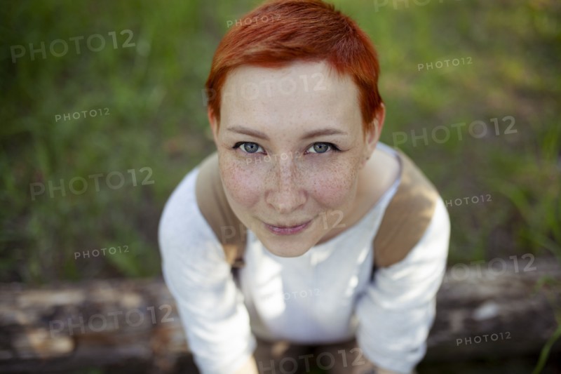 Portrait of smiling woman sitting on grass