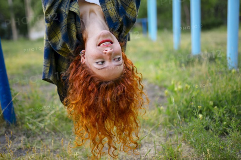 Upside down portrait of redhead woman looking away