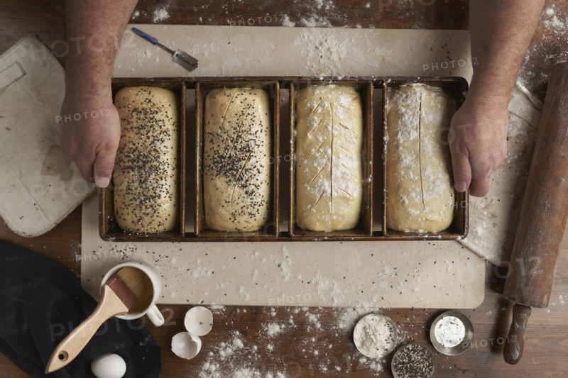 Directly above view of baker preparing bread in kitchen