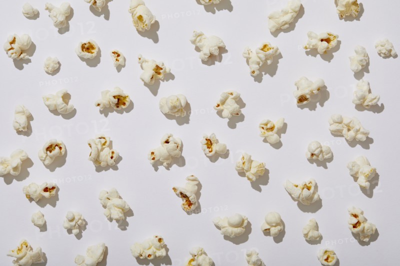 Overhead view of popcorn on white background, New York, NY, USA