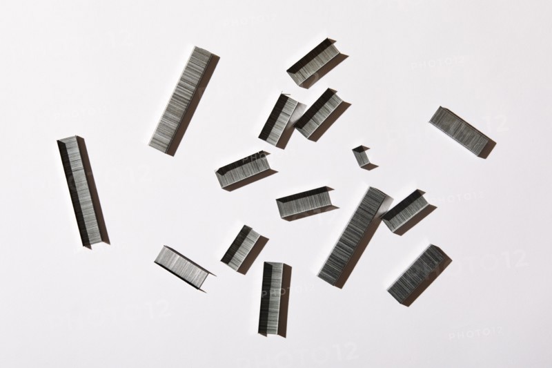 Overhead view of staples on white background, New York, NY, USA
