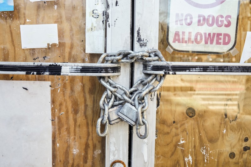 Close-up of chain and padlock on boarded up door, New York, NY, USA