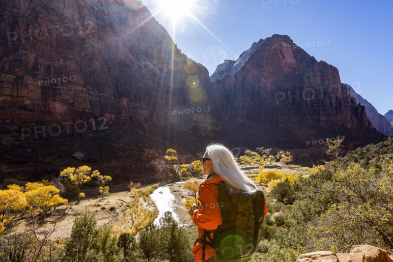 Woman hiking near Angels Landing Trail overlooking Virgin River, , Utah, USA