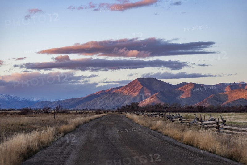 Empty dirt road leading to foothills at sunset, Bellevue, Idaho, USA