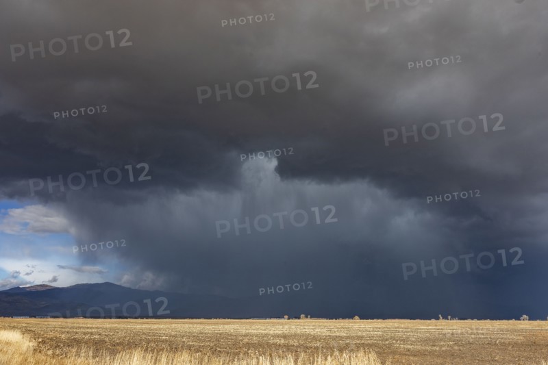 Dramatic storm clouds over field, Fairfield, Idaho, USA