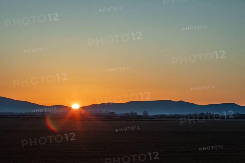 Sun setting behind hills near Sun Valley, Bellevue, Idaho, USA