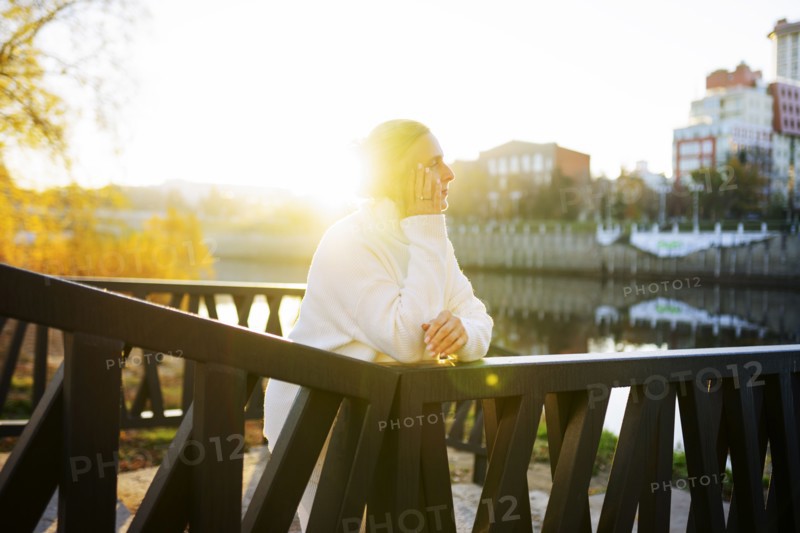 Woman in white sweater leaning on bridge, Omsk, , Russia