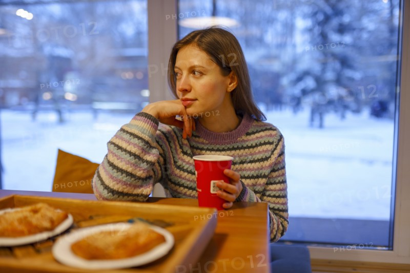 Portrait of woman having breakfast in cafe, Omsk, , Russia