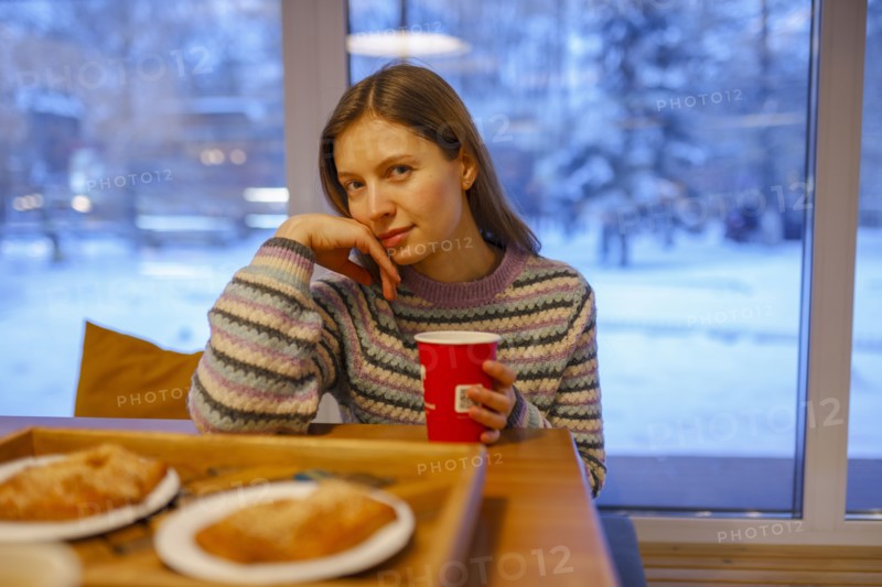 Portrait of woman having breakfast in cafe, Omsk, , Russia