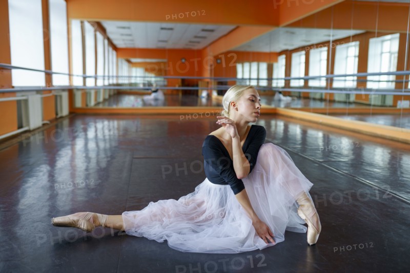 Portrait of ballerina sitting on floor in ballet studio, Omsk, , Russia