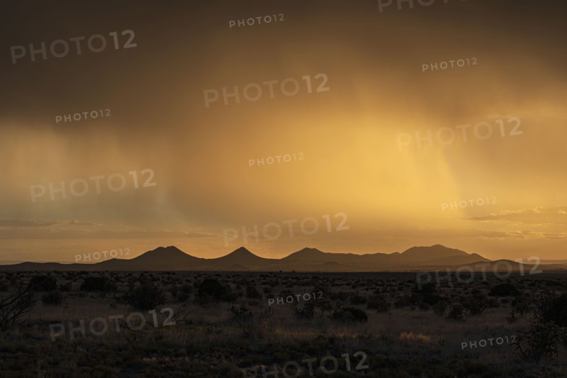 Usa, New Mexico, Santa Fe, Storm and rain over Cerrillos Hills at sunset, Santa Fe, New Mexico, USA
