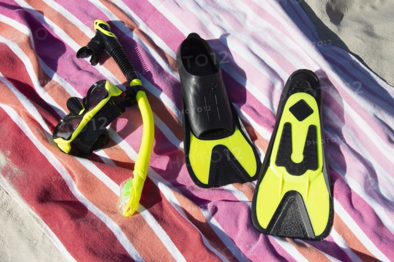 Snorkel mask and fins on beach towel, St. John, United States Virgin Islands, USA
