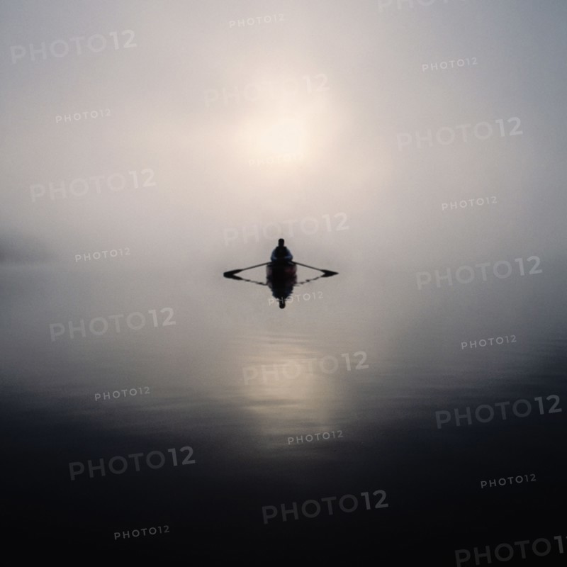 Man rowing boat in morning mist, Lake Placid, NY, USA, Lake Placid, New York, USA