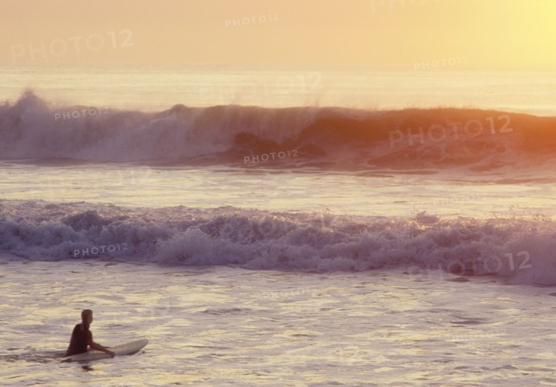 USA, NJ, Lone surfer on Spring Lake at sunrise, Spring Lake, New Jersey, USA