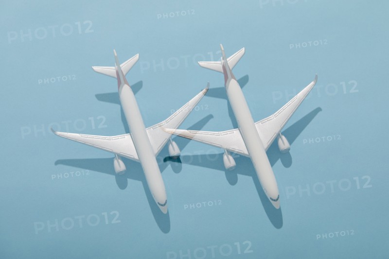 Overhead view of two model planes on blue background, New York, New York, USA