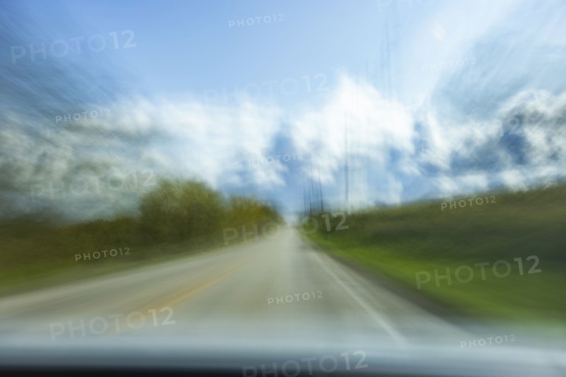USA, Wisconsin, Country road and clouds seen from moving car, Mt. Horeb, Wisconsin, USA