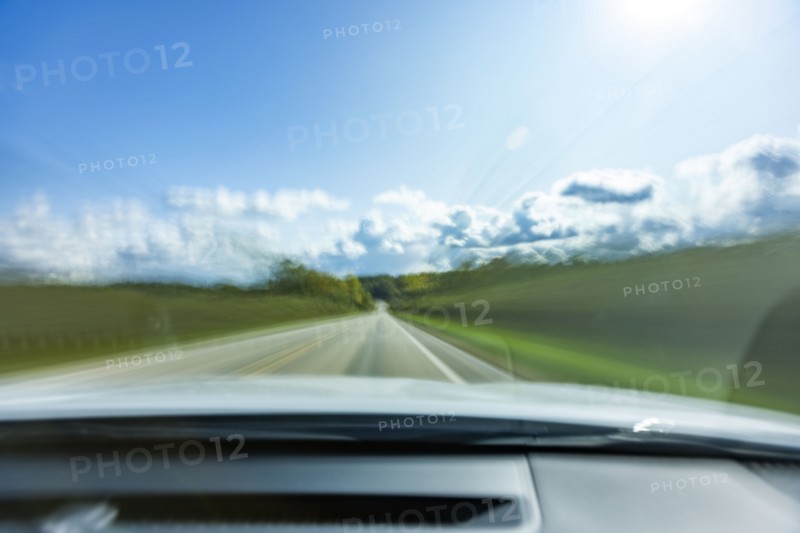USA, Wisconsin, Country road and clouds seen from moving car, Mt. Horeb, Wisconsin, USA