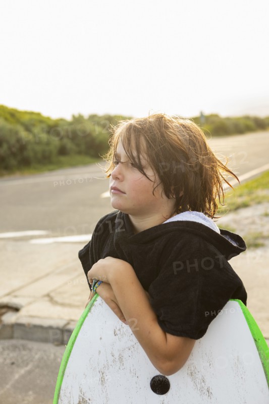 South Africa, Hermanus, Portrait of boy with surfboard and sister on beach, Hermanus, , South Africa