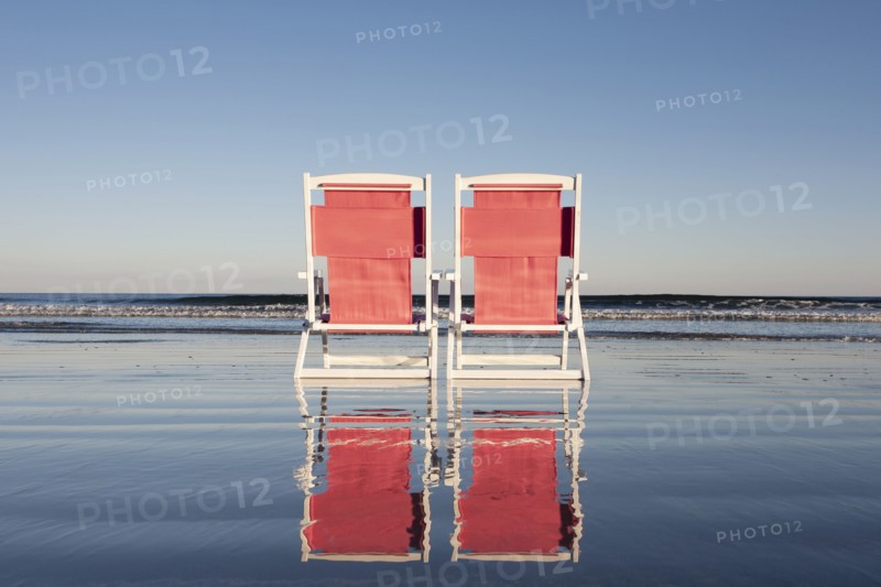 USA, Maine, York, Two beach chairs on wet sand beach, York, Maine, USA