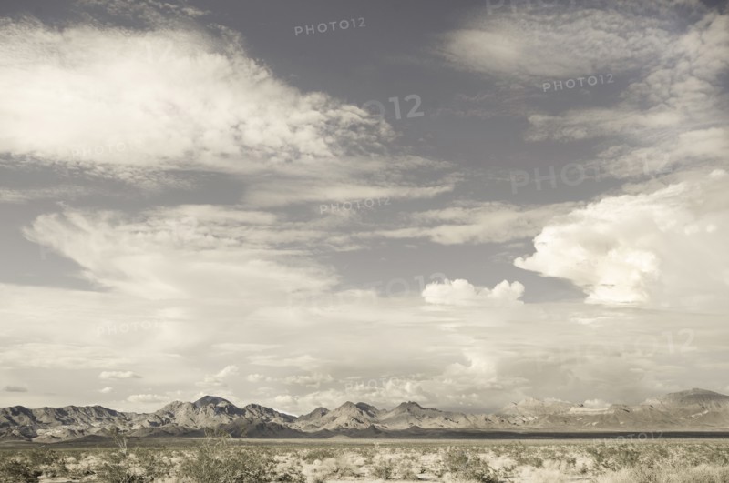 USA, California, Amboy, Clouds above barren hills in Mojave Desert, Amboy, California, USA
