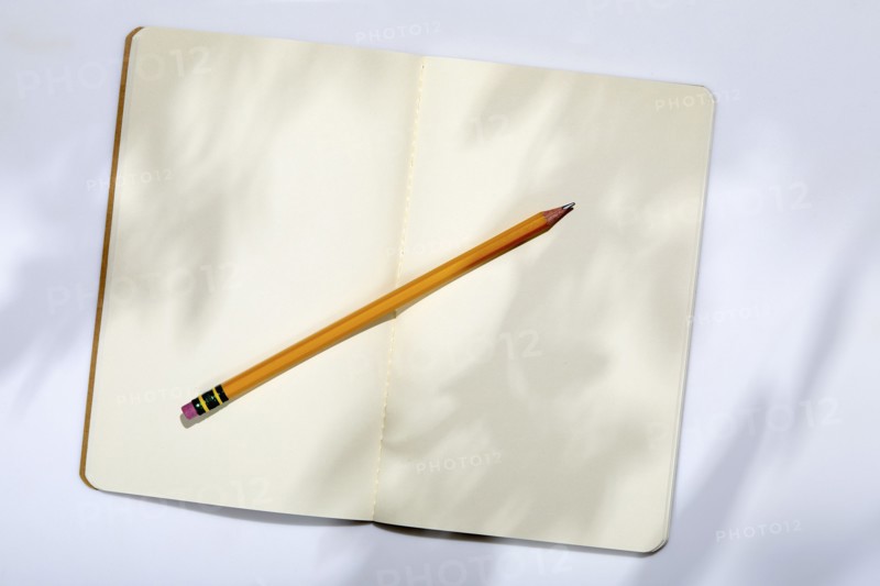 USA, New York State, New York City, Pencil on open note pad on white background, New York City, New York, USA