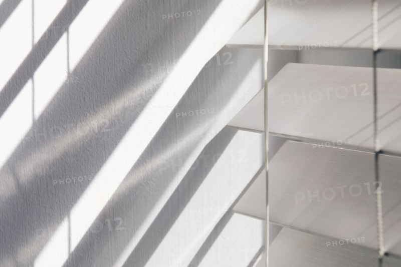 Close-up of white window blinds and shadows, New York City, New York, USA