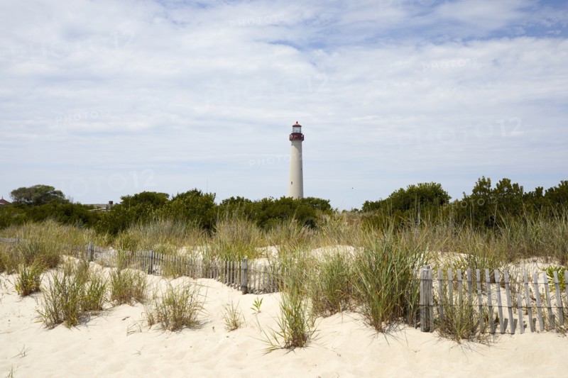 USA, New Jersey, Capy May, Grass on sand dunes with Cape May Lighthouse in distance, Capy May, New Jersey, USA