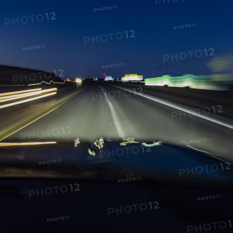 Highway at night seen from moving vehicle, blurred motion, Twin Falls, Idaho, USA