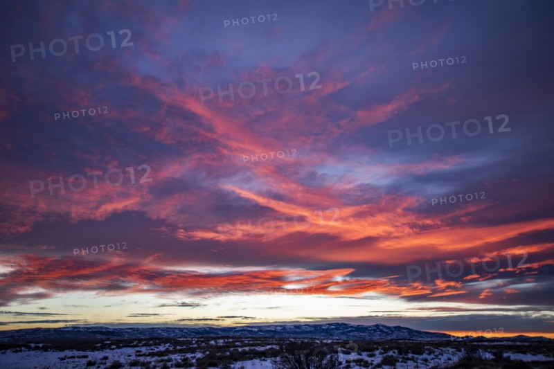 Blue and pink clouds over snow covered landscape at sunset, Fairfield, Idaho, USA