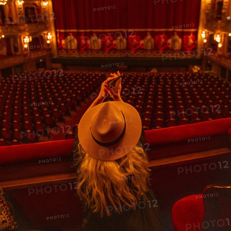 Rear view of woman in box seats of audience in Teatro Colon, Buenos Aires, , Argentina
