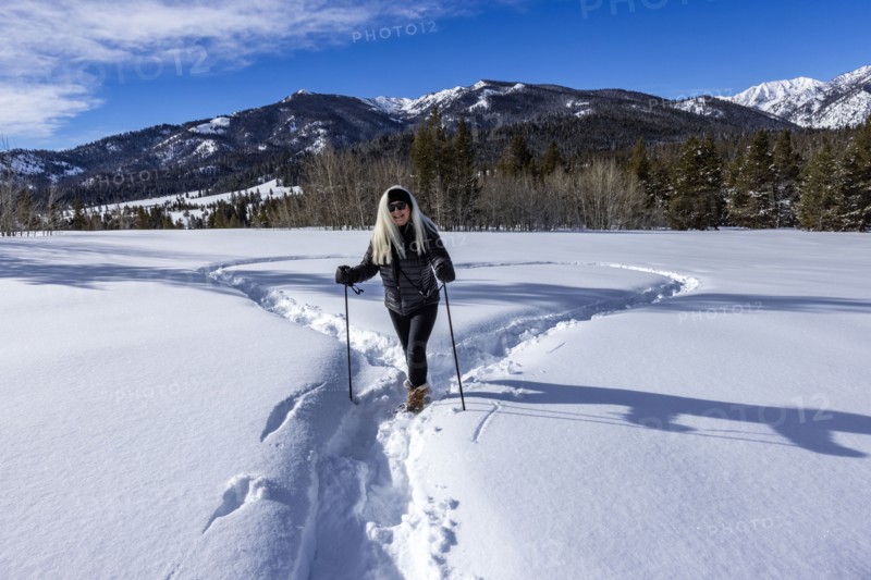 Smiling woman snowshoeing in winter landscape, Sun Valley, Idaho, USA
