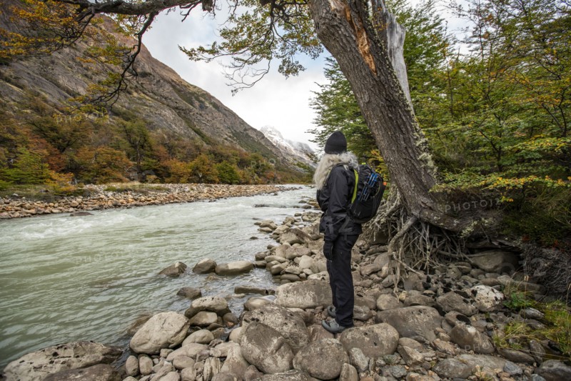 Argentina, Santa Cruz, El Chalten, Female hiker standing on rocks near Electrico River, El Chalten, Santa Cruz, Argentina