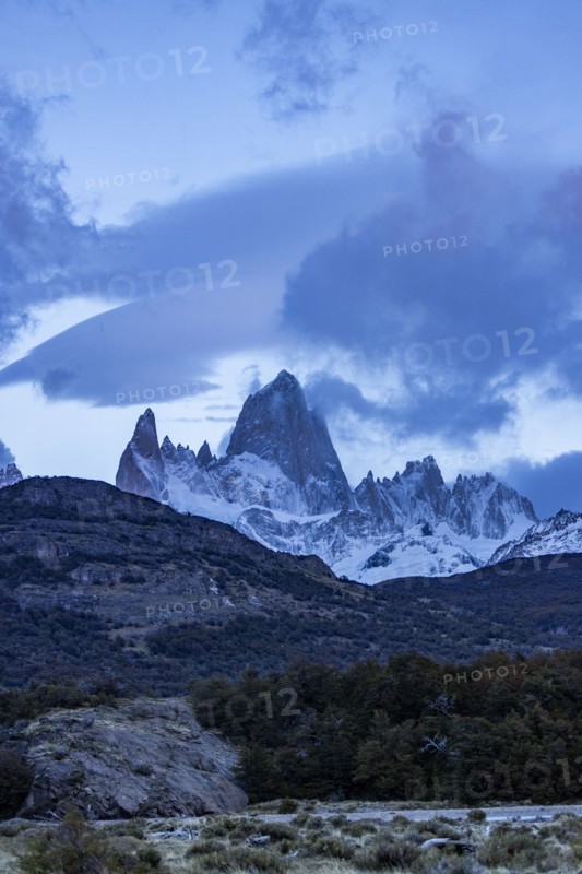 Argentina, Santa Cruz, El Chalten, Clouds above snow covered Mount Fitz Roy at sunset, El Chalten, Santa Cruz, Argentina