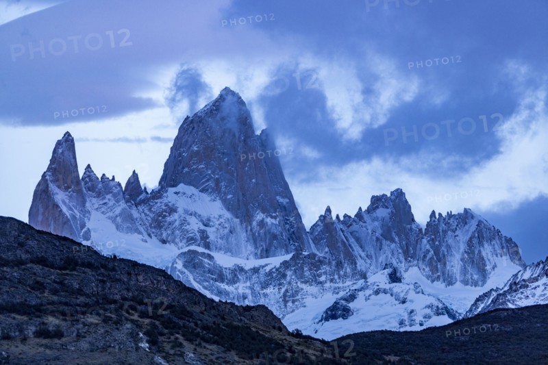 Argentina, Santa Cruz, El Chalten, Clouds above snow covered Mount Fitz Roy at sunset, El Chalten, Santa Cruz, Argentina