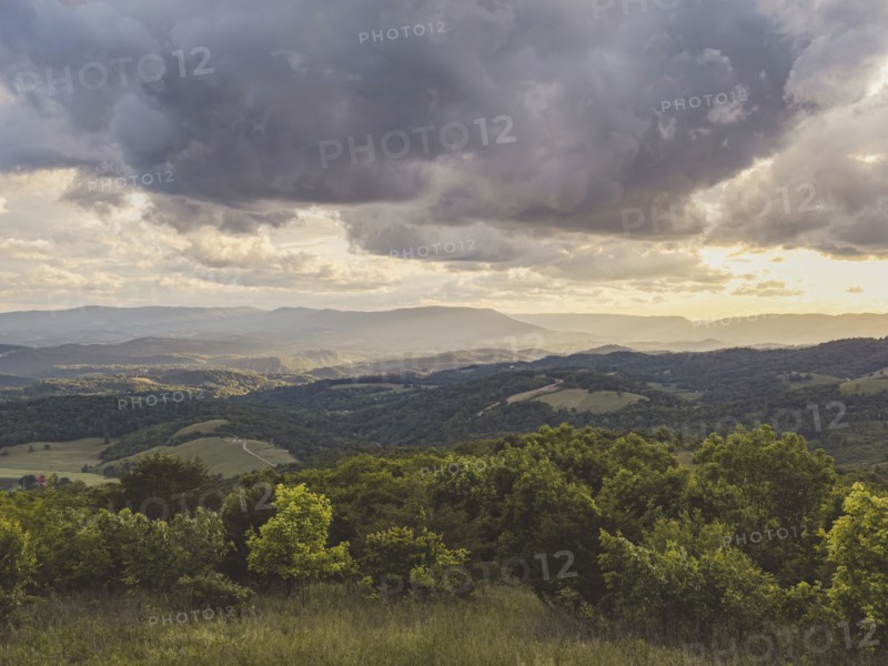 USA, Virginia, Newport, Storm clouds over hilly landscape at sunset, Newport, Virginia, USA