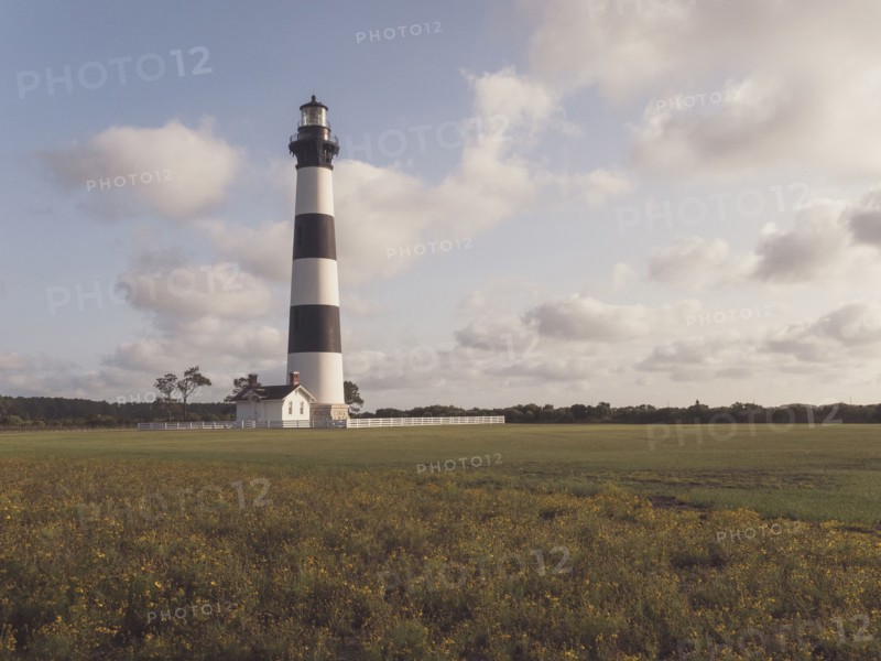 USA, North Carolina, Nags Head, Bodie Island Lighthouse in grassy field, Nags Head, North Carolina, USA