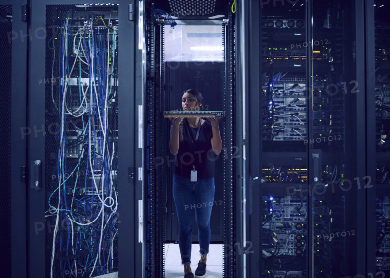 Female technician holding hard drive in server room
St, George, Utah, USA