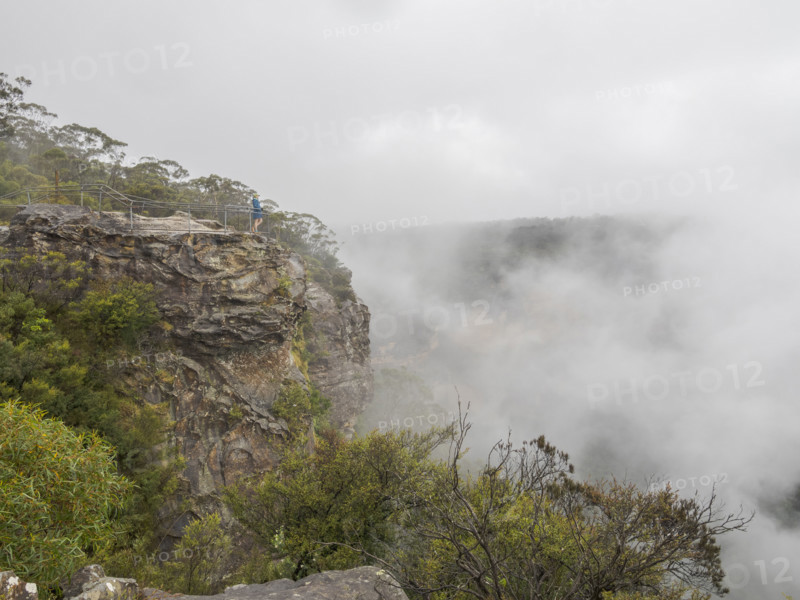 Hiker standing on observation point on top of mountain covered with clouds
Katoomba, New South Wales, Australia