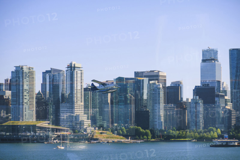 Seaplane flying above Burrard Inlet, downtown buildings in background
Vancouver, British Columbia, Canada