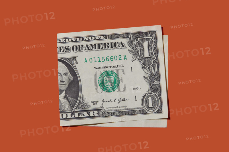 Folded one dollar bill on orange background
New York City, New York State, USA