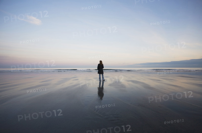 Rear view of woman standing on beach at sunset
York Beach, Maine, USA