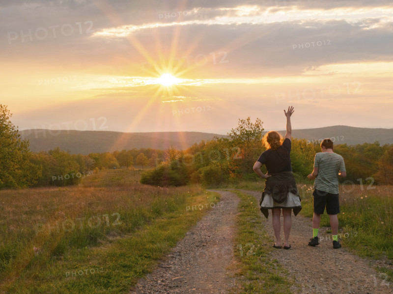 Rear view of mother and son (16-17) standing on dirt road in landscape at sunset
Blacksburg, Virginia, USA